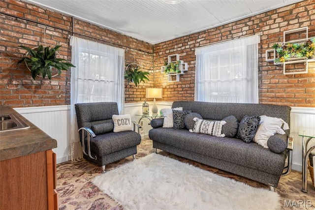 698N 3rd St, Saint Genevieve, MO 63670 - living room featuring brick wall and wainscoting