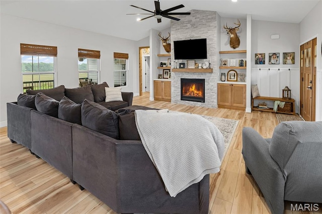 8353 Maple Grove Rd, Troy, IL 62294 - living room featuring vaulted ceiling, a ceiling fan, light wood-style flooring, and a fireplace