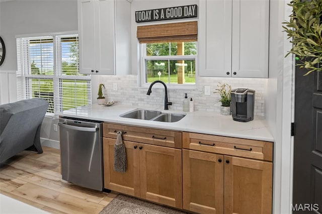 8353 Maple Grove Rd, Troy, IL 62294 - kitchen with stainless steel dishwasher, light wood-style flooring, tasteful backsplash, and healthy amount of natural light
