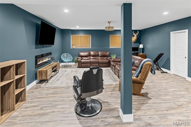 8353 Maple Grove Rd, Troy, IL 62294 - living room with wood finished floors, recessed lighting, and a glass covered fireplace