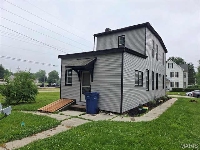 107 N 18th St, Belleville, IL 62226 - view of property exterior featuring a lawn and a chimney