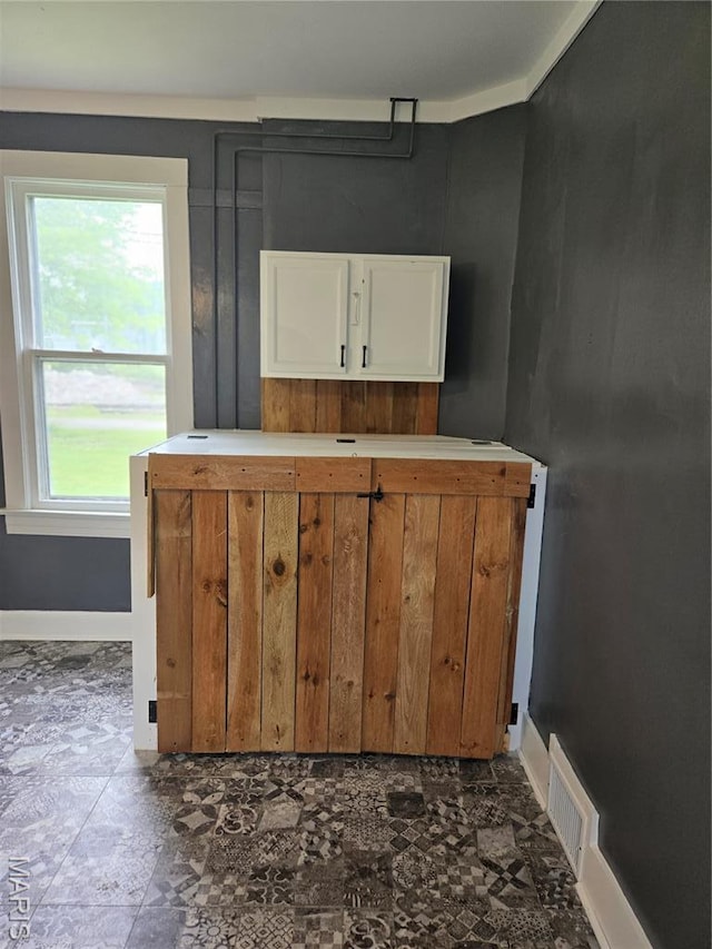 107 N 18th St, Belleville, IL 62226 - kitchen featuring white cabinets, baseboards, and light countertops