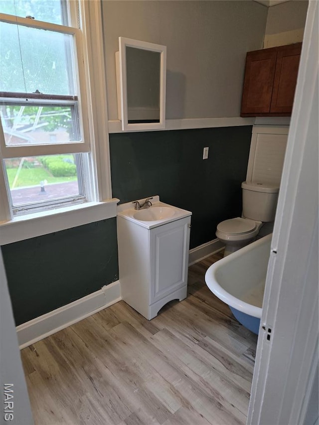 107 N 18th St, Belleville, IL 62226 - half bathroom featuring toilet, wood finished floors, vanity, and baseboards