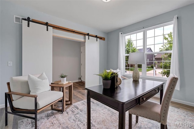 803 Brimley Dr, Cottleville, MO 63304 - home office with a barn door and light wood-style flooring