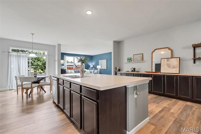 803 Brimley Dr, Cottleville, MO 63304 - kitchen featuring light countertops, stainless steel dishwasher, dark brown cabinetry, and light wood finished floors