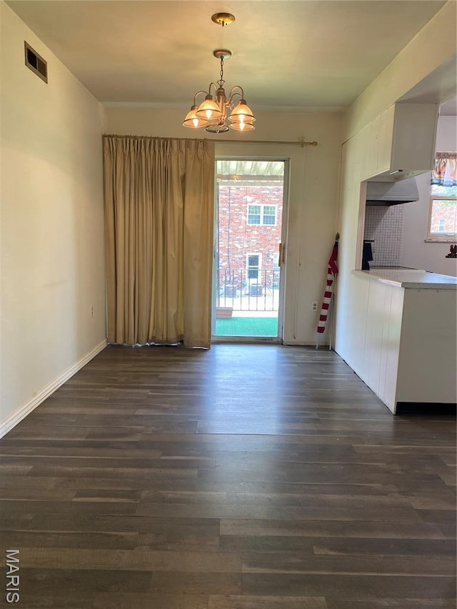 3122 Carnaby Ln Unit C, Bridgeton, MO 63044 - unfurnished dining area featuring dark wood-style floors, a chandelier, and healthy amount of natural light