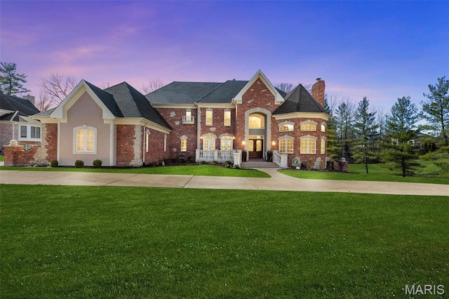 1315 Wildhorse Meadows Dr, Chesterfield, MO 63005 - view of front of house with a chimney, a front lawn, and brick siding