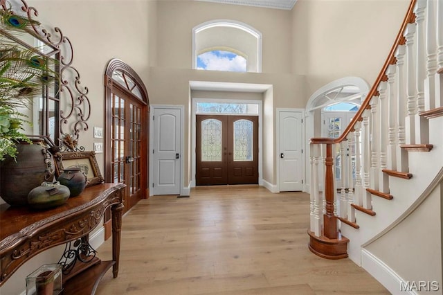 1315 Wildhorse Meadows Dr, Chesterfield, MO 63005 - foyer with french doors, healthy amount of natural light, light wood finished floors, and a high ceiling