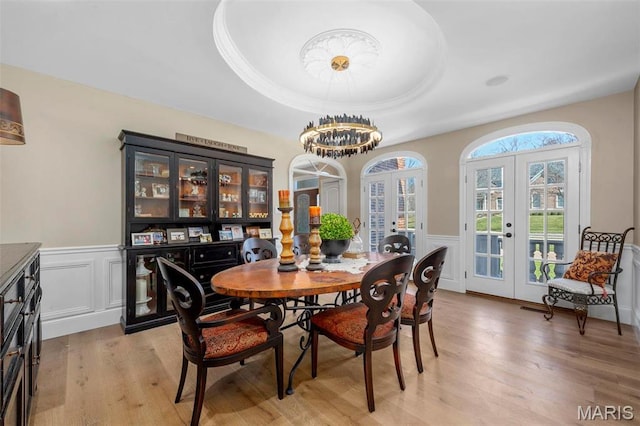 1315 Wildhorse Meadows Dr, Chesterfield, MO 63005 - dining space featuring french doors, light wood-style flooring, a wainscoted wall, a decorative wall, and a chandelier