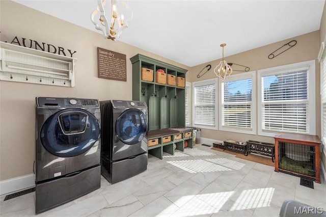 1315 Wildhorse Meadows Dr, Chesterfield, MO 63005 - laundry area featuring a chandelier, washing machine and clothes dryer, and baseboards