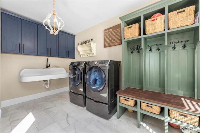 1315 Wildhorse Meadows Dr, Chesterfield, MO 63005 - laundry room featuring light marble finish floors, a chandelier, washer and clothes dryer, and baseboards