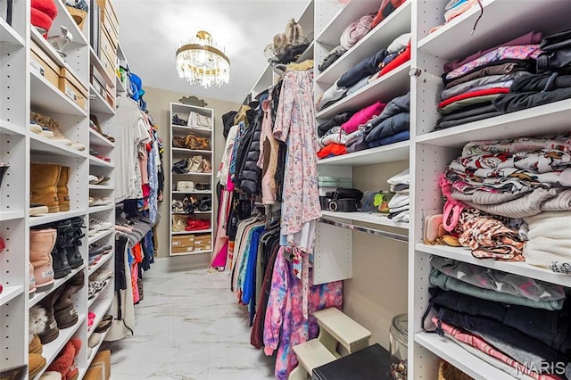 1315 Wildhorse Meadows Dr, Chesterfield, MO 63005 - walk in closet with marble look tile flooring and a chandelier