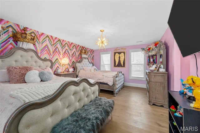 1315 Wildhorse Meadows Dr, Chesterfield, MO 63005 - bedroom with wood finished floors, an accent wall, baseboards, and wallpapered walls