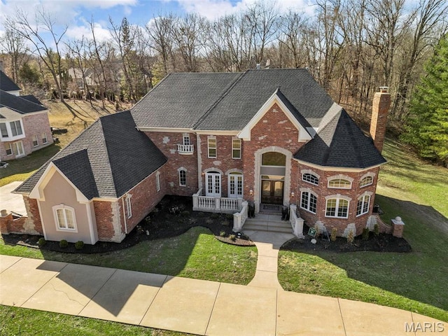 1315 Wildhorse Meadows Dr, Chesterfield, MO 63005 - view of front of house featuring a chimney, brick siding, a front yard, and a shingled roof