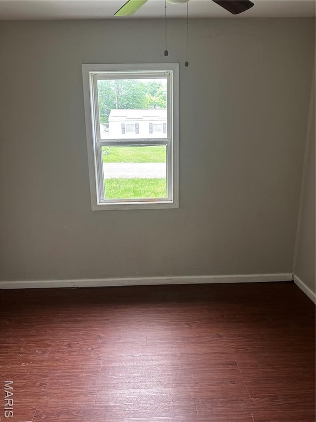 35 Saint Justin Dr E, St Louis, IL 62206 - empty room with wood finished floors, baseboards, and ceiling fan