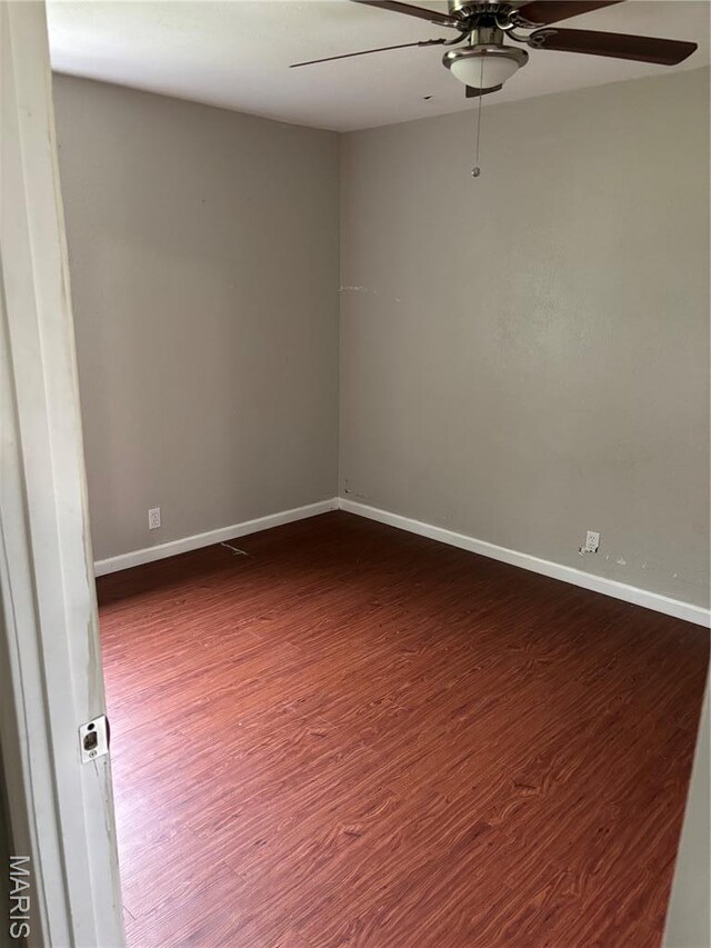 35 Saint Justin Dr E, St Louis, IL 62206 - unfurnished room featuring a ceiling fan, dark wood finished floors, and baseboards