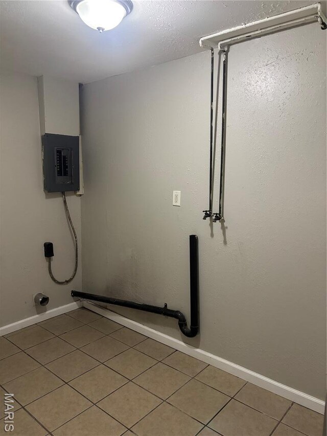 35 Saint Justin Dr E, St Louis, IL 62206 - washroom with electric panel, light tile patterned flooring, and baseboards