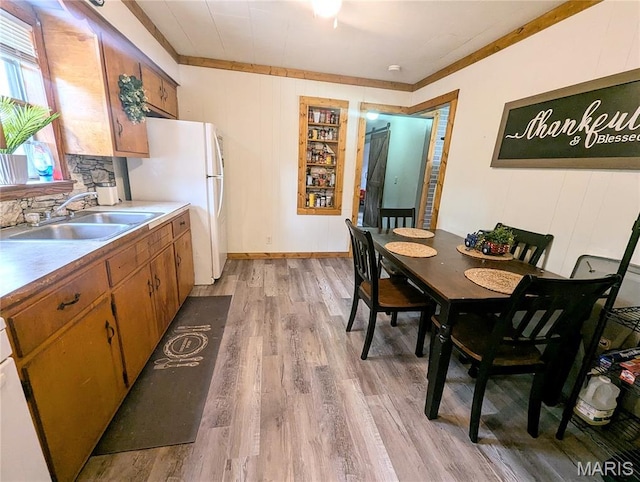 200 N Elm St, Campbell, MO 63933 - dining room with light wood-style flooring and crown molding