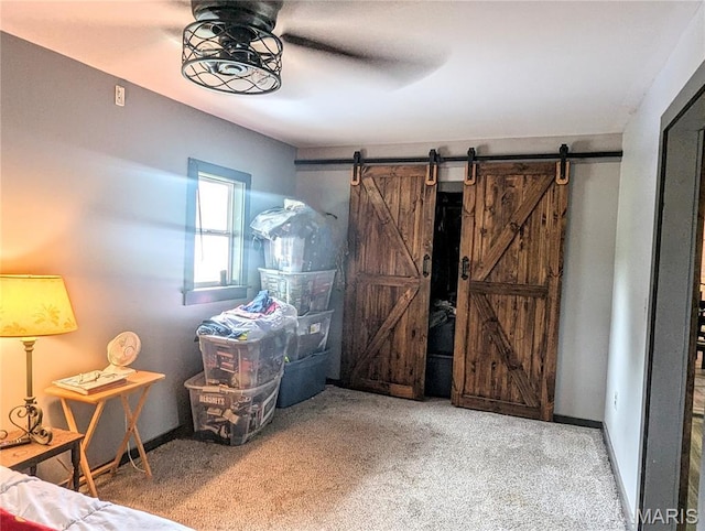 200 N Elm St, Campbell, MO 63933 - bedroom with a barn door, carpet floors, baseboards, and ceiling fan