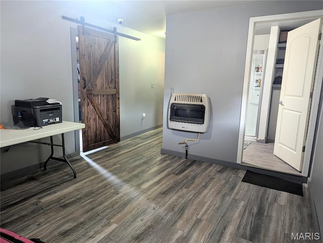 200 N Elm St, Campbell, MO 63933 - kitchen featuring a barn door, heating unit, and wood finished floors
