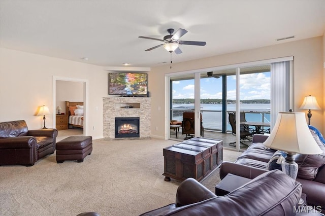 18051 Blue Anchor Dr Unit 533, Gravois Mills, MO 65037 - living area with carpet floors, ceiling fan, a water view, and a fireplace