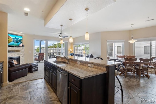 18051 Blue Anchor Dr Unit 533, Gravois Mills, MO 65037 - kitchen with stainless steel dishwasher, open floor plan, a sink, stone tile floors, and a kitchen bar