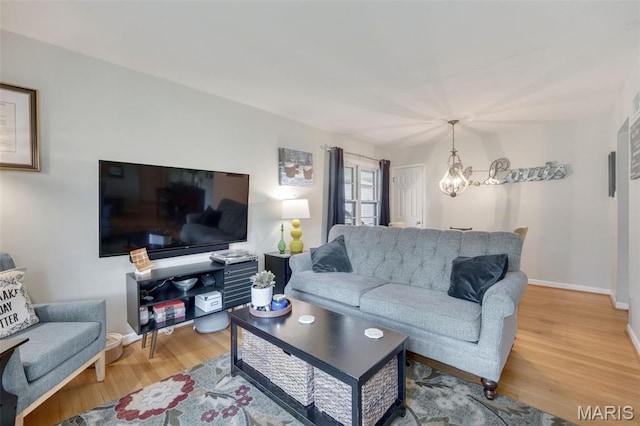 169 W Kirkham Ave, Webster Groves, MO 63119 - living room featuring light wood-type flooring and a chandelier