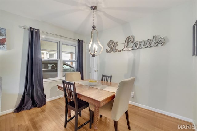 169 W Kirkham Ave, Webster Groves, MO 63119 - dining area featuring light wood-style floors and a chandelier