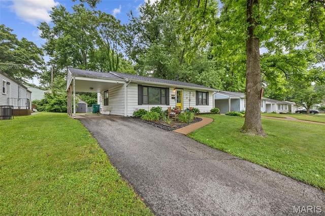 169 W Kirkham Ave, Webster Groves, MO 63119 - single story home with a front lawn, asphalt driveway, and a carport