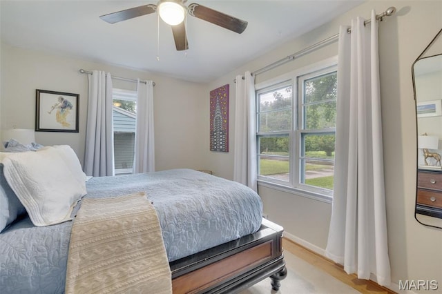 169 W Kirkham Ave, Webster Groves, MO 63119 - bedroom with multiple windows, light wood-style flooring, and ceiling fan