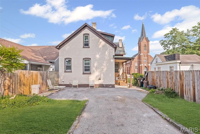 27 N 14th St, Belleville, IL 62220 - rear view of property with a chimney and brick siding