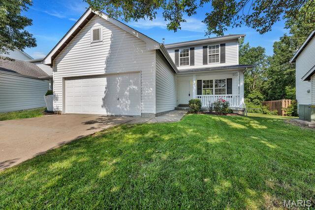 1305 Flintshire Ln, Lake St Louis, MO 63367 - traditional home with a garage, a porch, and concrete driveway