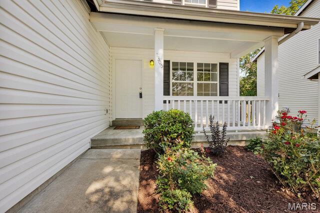 1305 Flintshire Ln, Lake St Louis, MO 63367 - property entrance featuring a porch
