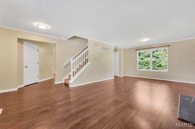 1305 Flintshire Ln, Lake St Louis, MO 63367 - unfurnished living room with crown molding, wood finished floors, and stairs