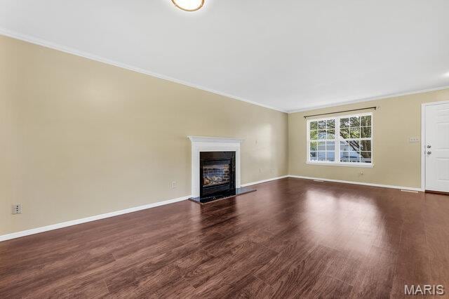 1305 Flintshire Ln, Lake St Louis, MO 63367 - unfurnished living room featuring crown molding, dark wood finished floors, and a fireplace with raised hearth