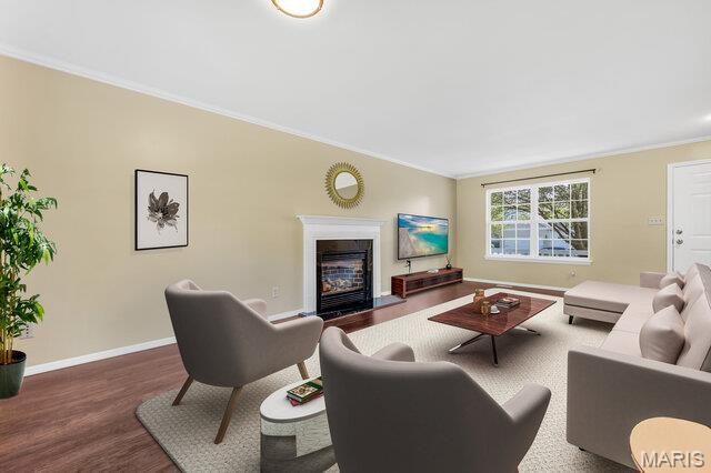 1305 Flintshire Ln, Lake St Louis, MO 63367 - living area with crown molding, wood finished floors, and a fireplace with flush hearth