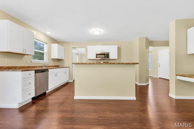 1305 Flintshire Ln, Lake St Louis, MO 63367 - kitchen featuring appliances with stainless steel finishes, dark wood-style flooring, and white cabinets