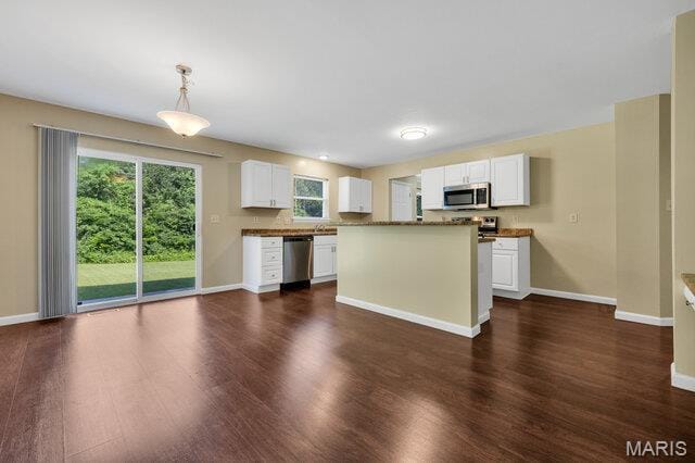 1305 Flintshire Ln, Lake St Louis, MO 63367 - kitchen with stainless steel appliances, dark wood-style floors, white cabinetry, hanging light fixtures, and a center island