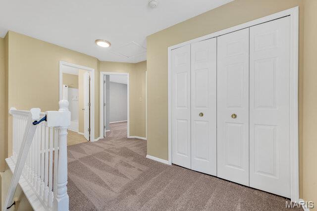 1305 Flintshire Ln, Lake St Louis, MO 63367 - hallway featuring carpet flooring and baseboards