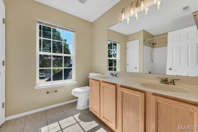 1305 Flintshire Ln, Lake St Louis, MO 63367 - full bathroom with a shower, double vanity, and tile patterned floors