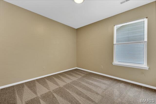 1305 Flintshire Ln, Lake St Louis, MO 63367 - carpeted empty room with baseboards