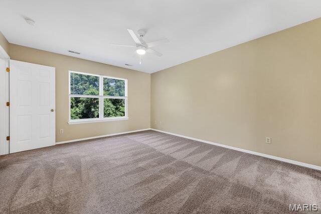 1305 Flintshire Ln, Lake St Louis, MO 63367 - empty room with ceiling fan and carpet floors