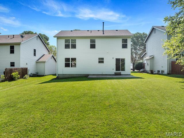 1305 Flintshire Ln, Lake St Louis, MO 63367 - back of house featuring a patio area and a yard
