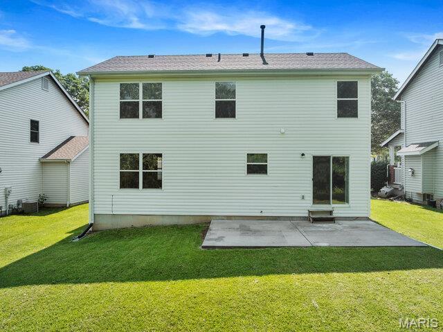 1305 Flintshire Ln, Lake St Louis, MO 63367 - back of property featuring a lawn and a patio area