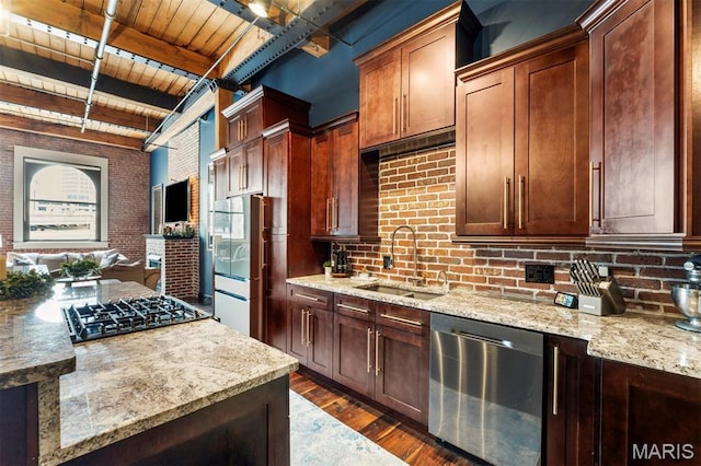 901 Washington Ave Unit 702, Saint Louis, MO 63101 - kitchen featuring appliances with stainless steel finishes, a sink, wooden ceiling with exposed beams, dark wood finished floors, and brick wall