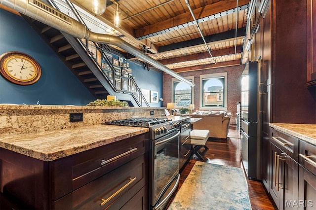 901 Washington Ave Unit 702, Saint Louis, MO 63101 - kitchen featuring gas range oven, wood ceiling with exposed beams, dark wood finished floors, open floor plan, and dark brown cabinetry