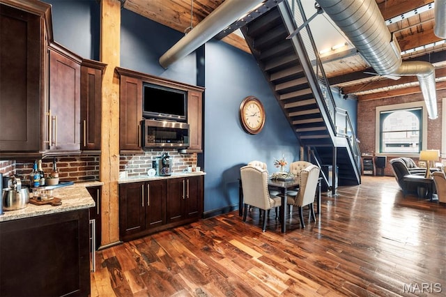 901 Washington Ave Unit 702, Saint Louis, MO 63101 - dining area with stairway, dark wood finished floors, and wood ceiling