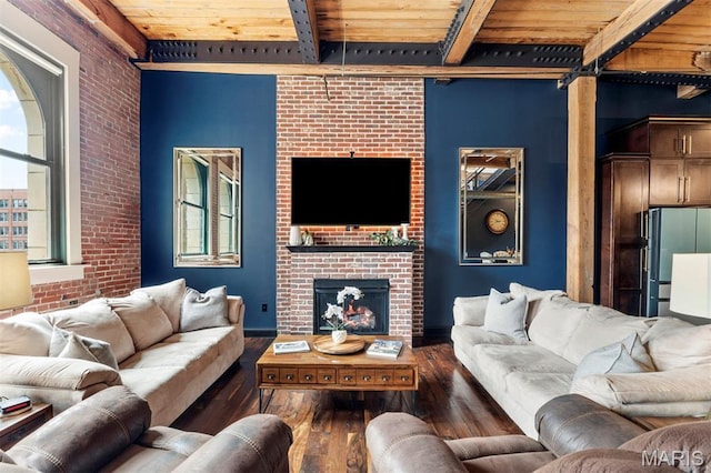 901 Washington Ave Unit 702, Saint Louis, MO 63101 - living room featuring wood ceiling with exposed beams, hardwood / wood-style flooring, a brick fireplace, and brick wall