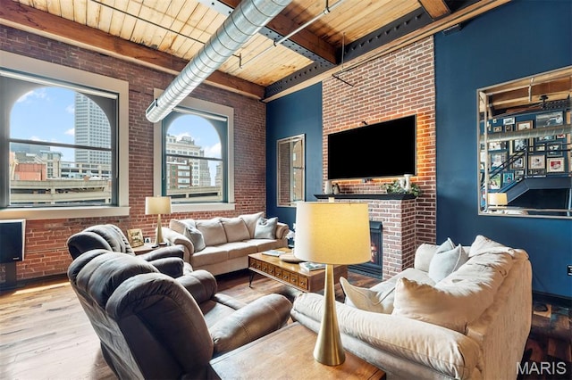 901 Washington Ave Unit 702, Saint Louis, MO 63101 - living room featuring brick wall, wood ceiling with exposed beams, wood finished floors, and a fireplace