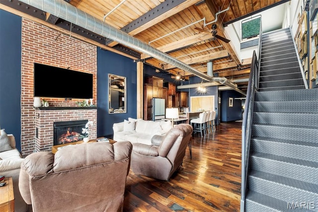 901 Washington Ave Unit 702, Saint Louis, MO 63101 - living room featuring dark wood-style floors, stairs, wood ceiling with exposed beams, and a fireplace